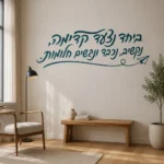 מדבקת טקסט עברי עם מטוס נייר על קיר בסלון עם ספה אפורה ותאורה רכה