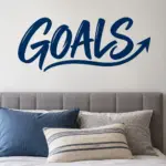 מדבקת המילה 'GOALS' בשחור על קיר חדר ילדים עם שולחן כתיבה ולוח שעם.